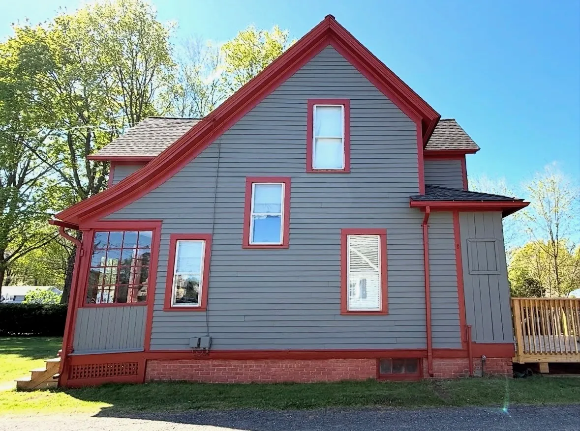 After — Victorian home repainted in period colors (side)